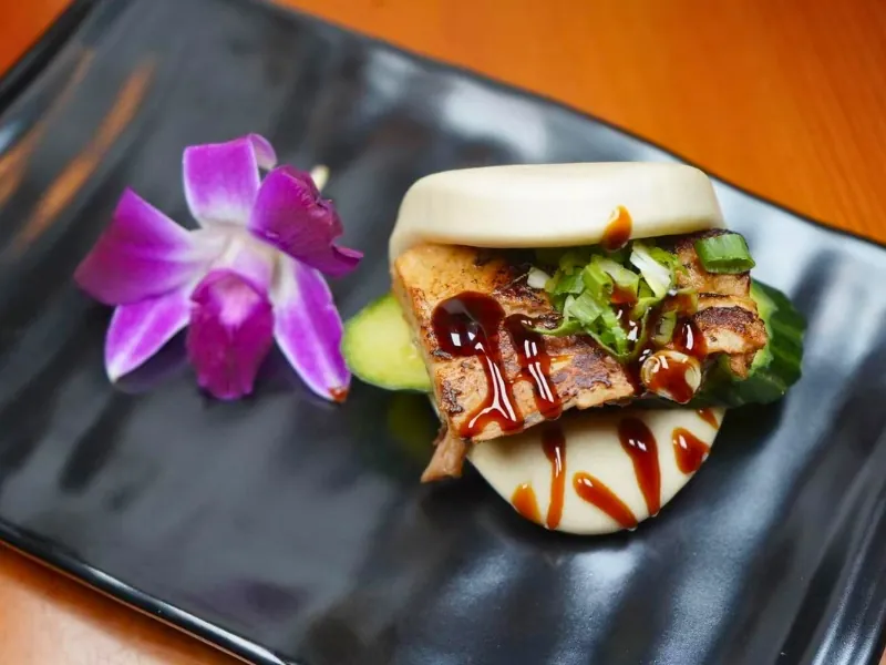 Stuffed bao bun with grilled filling, sauce & veggies at Koi Ramen & Sushi, a Japanese Restaurant in Johnstown