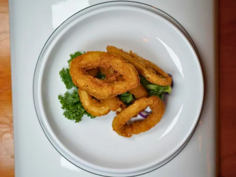 Crispy fried onion rings with greens at Koi Ramen & Sushi, a Japanese Restaurant in Johnstown